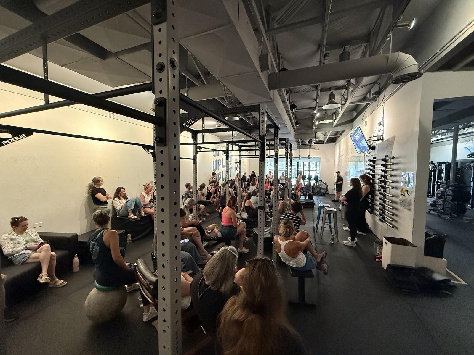 Attendees seated throughout the gym for the Heavy Lifting for Women seminar